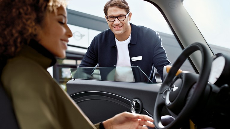 Woman in MINI with male sales rep